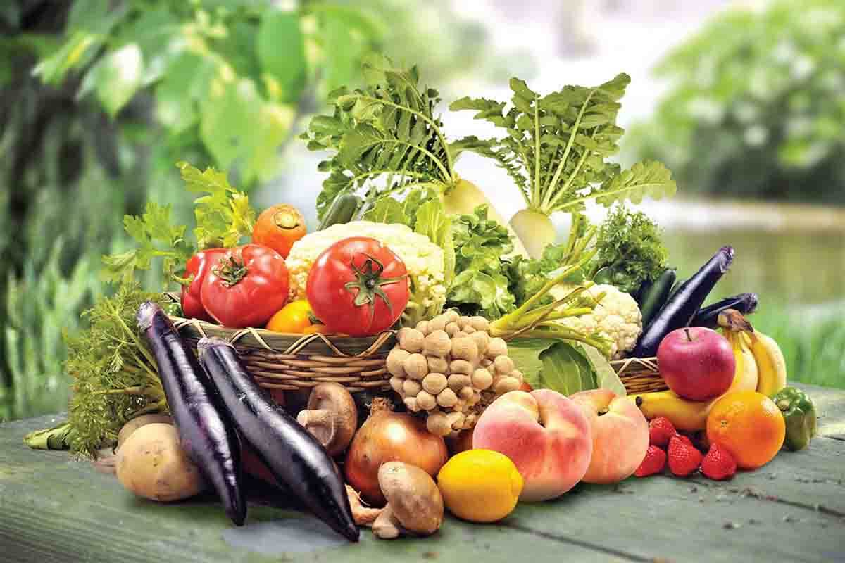 Fresh vegetables and fruits on wooden table.