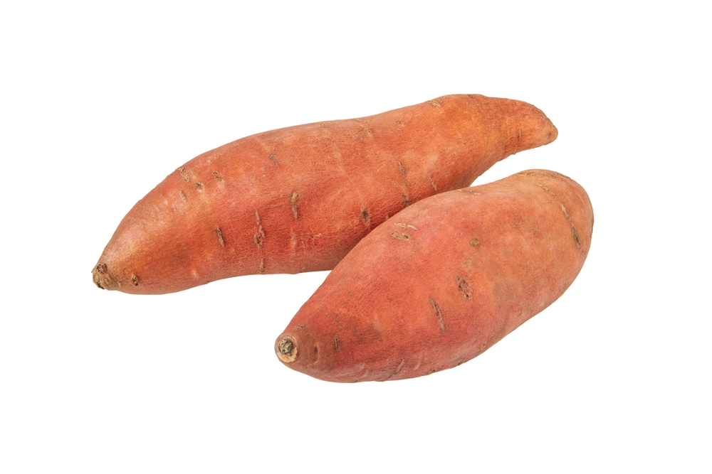 Two whole sweet potatoes on white background.