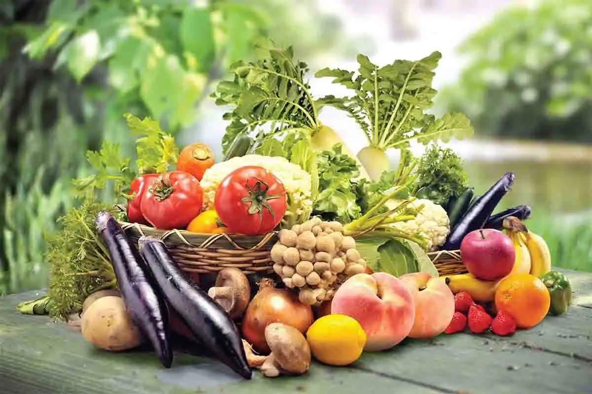 Fresh fruits and vegetables on wooden table.