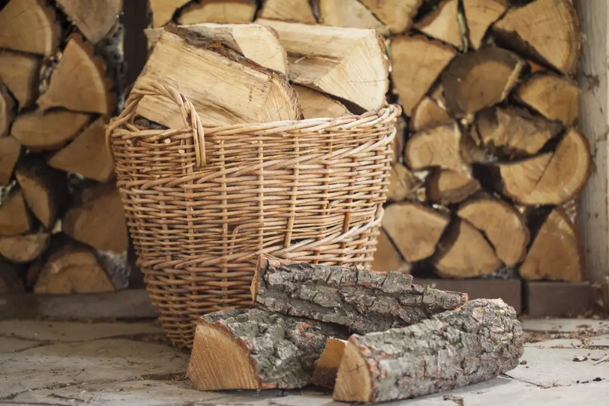 Basket and stack of firewood logs.
